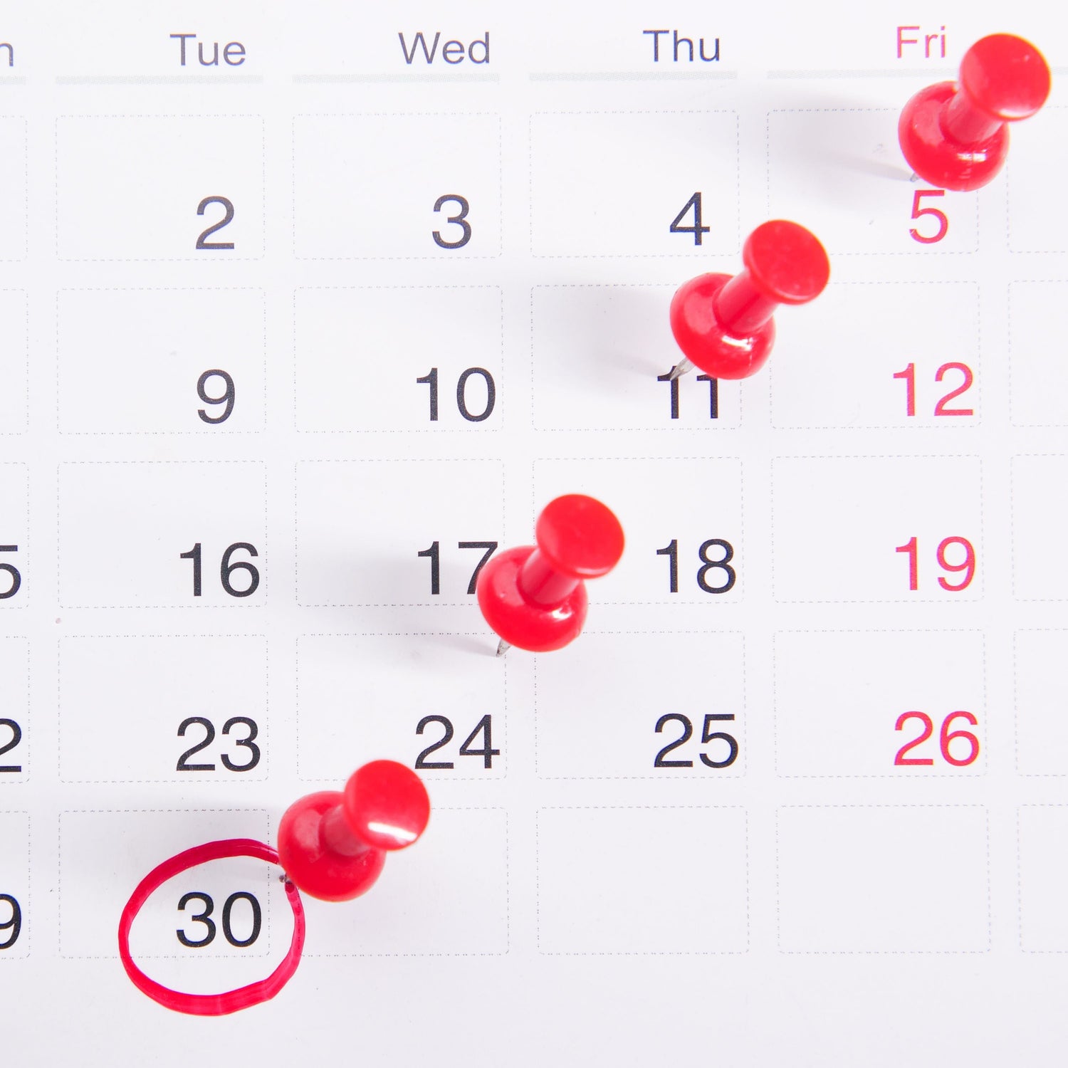 Paper calendar page, Sunday through Friday, with red thumbtacks on the 5th, 11th, 17th, and, 24th, and 30th. The 30th is circled in red.