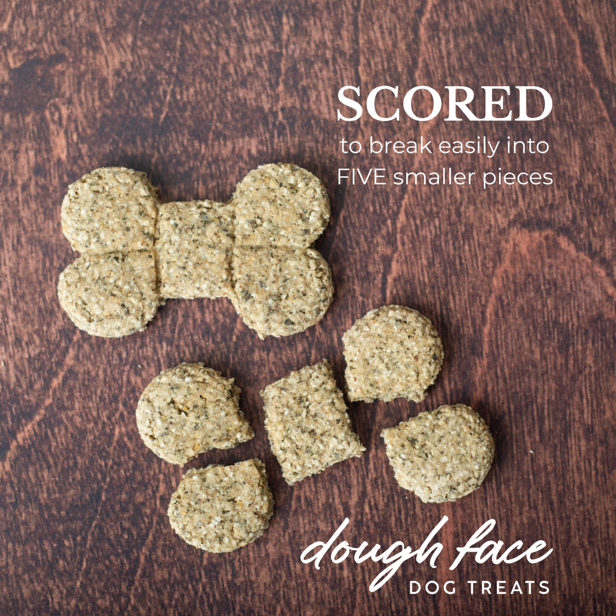 Two bone shaped dog treats on a wood textured background. One treat is intact, the other is broken into five pieces. The words "SCORED to break easily into FIVE smaller pieces" are in the top right hand corner and "dough face DOG TREATS" in the bottom right hand corner.