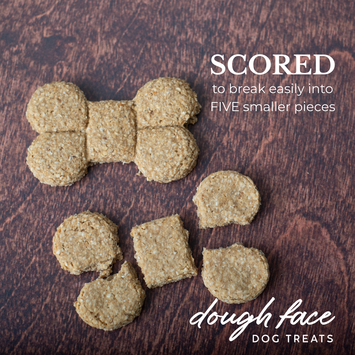 Two bone shaped dog treats on a wood textured background. One treat is intact, the other is broken into five pieces. The words "SCORED to break easily into FIVE smaller pieces" are in the top right hand corner and "dough face DOG TREATS" in the bottom right hand corner.