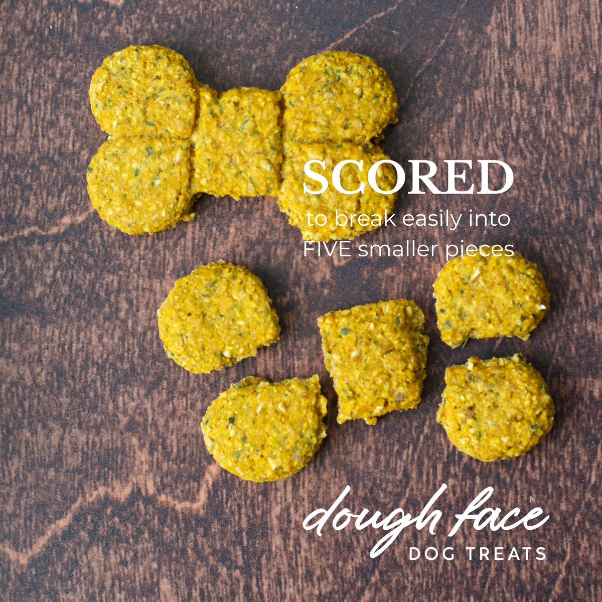 Two bone shaped dog treats on a wood textured background. One treat is intact, the other is broken into five pieces. The words "SCORED to break easily into FIVE smaller pieces" are in the top right hand corner and "dough face DOG TREATS" in the bottom right hand corner.