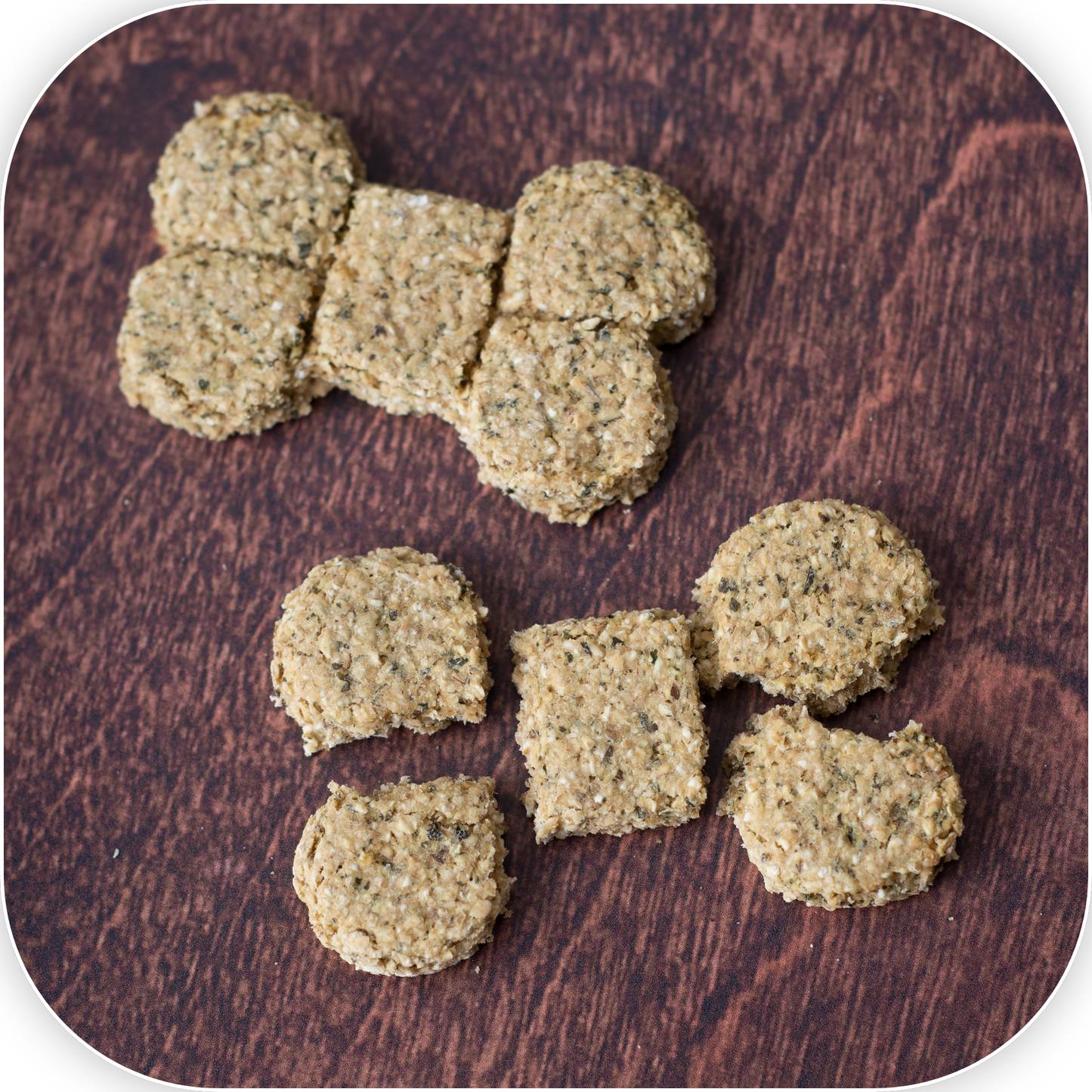 Dough Face Dog Treats bone shaped scored dog treat next to a treat broken into five pieces.