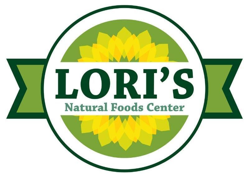A circular logo for Lori's Natural Foods Center, featuring a white center with dark green text, a yellow flower motif on a light green background, and a dark green ribbon banner extending to the sides.