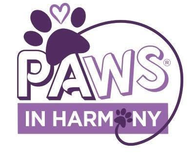 A purple and white logo for Paws in Harmony, featuring a paw print with a heart above the stylized text 'PAWS IN HARMONY' on a white background.