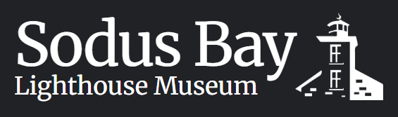 White text reading 'Sodus Bay Lighthouse Museum' on a dark charcoal background, with a white lighthouse illustration at the right.