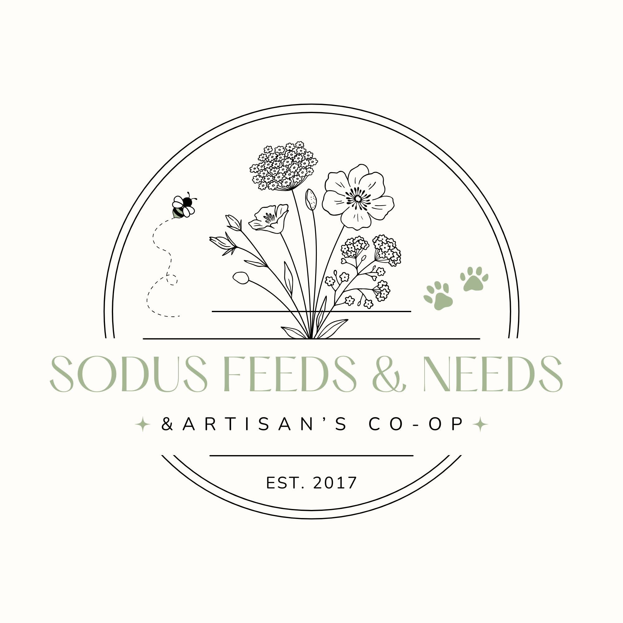 A circular logo design for 'SODUS FEEDS & NEEDS & ARTISAN'S CO-OP' featuring black line art of wildflowers, a bee, and a butterfly, with two sage green paw prints on a light cream background.