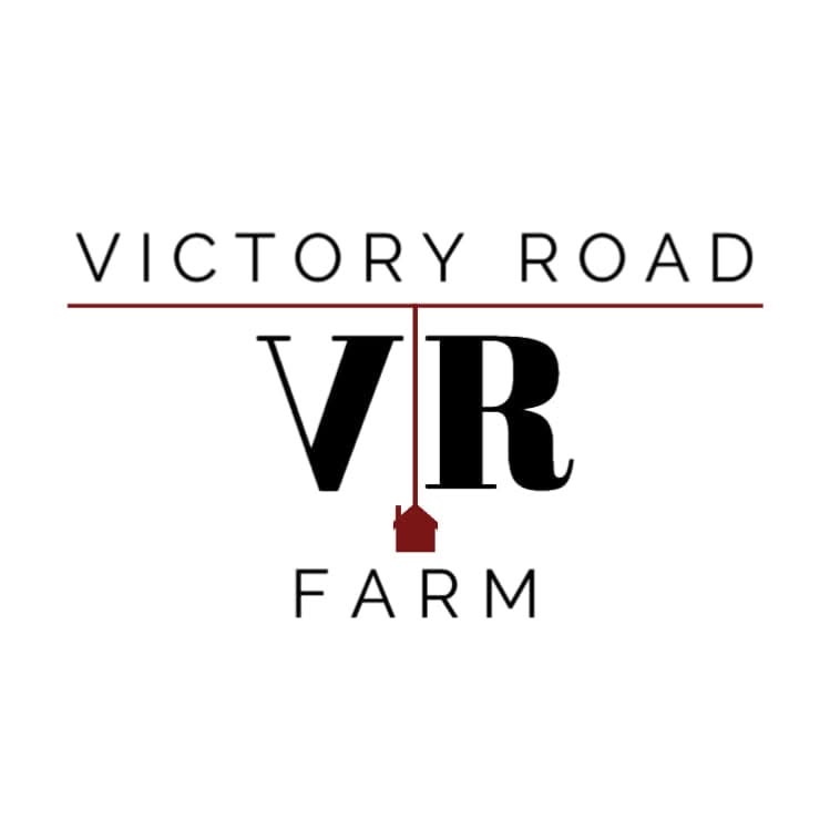 Victory Road VR Farm logo on a white background, featuring black serif text and a small dark red house icon.